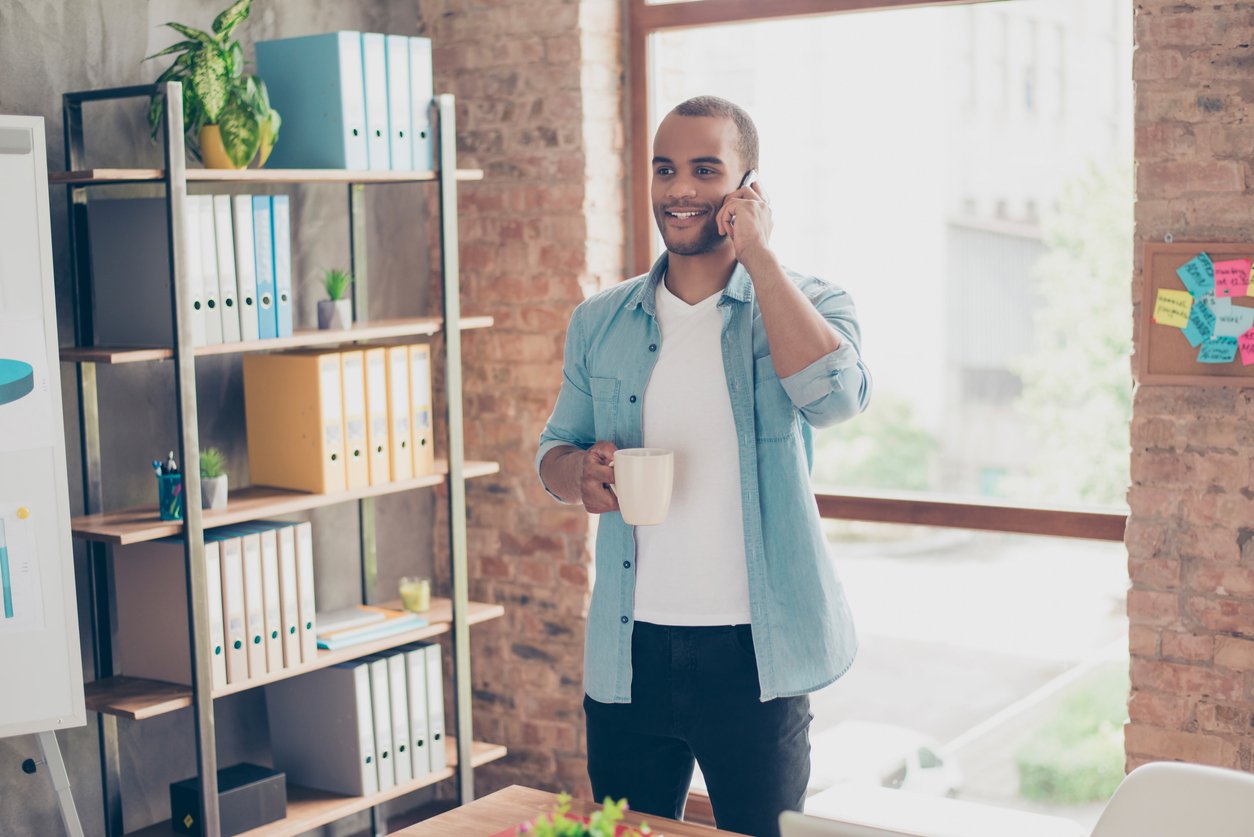 Man on a cell phone in a home office