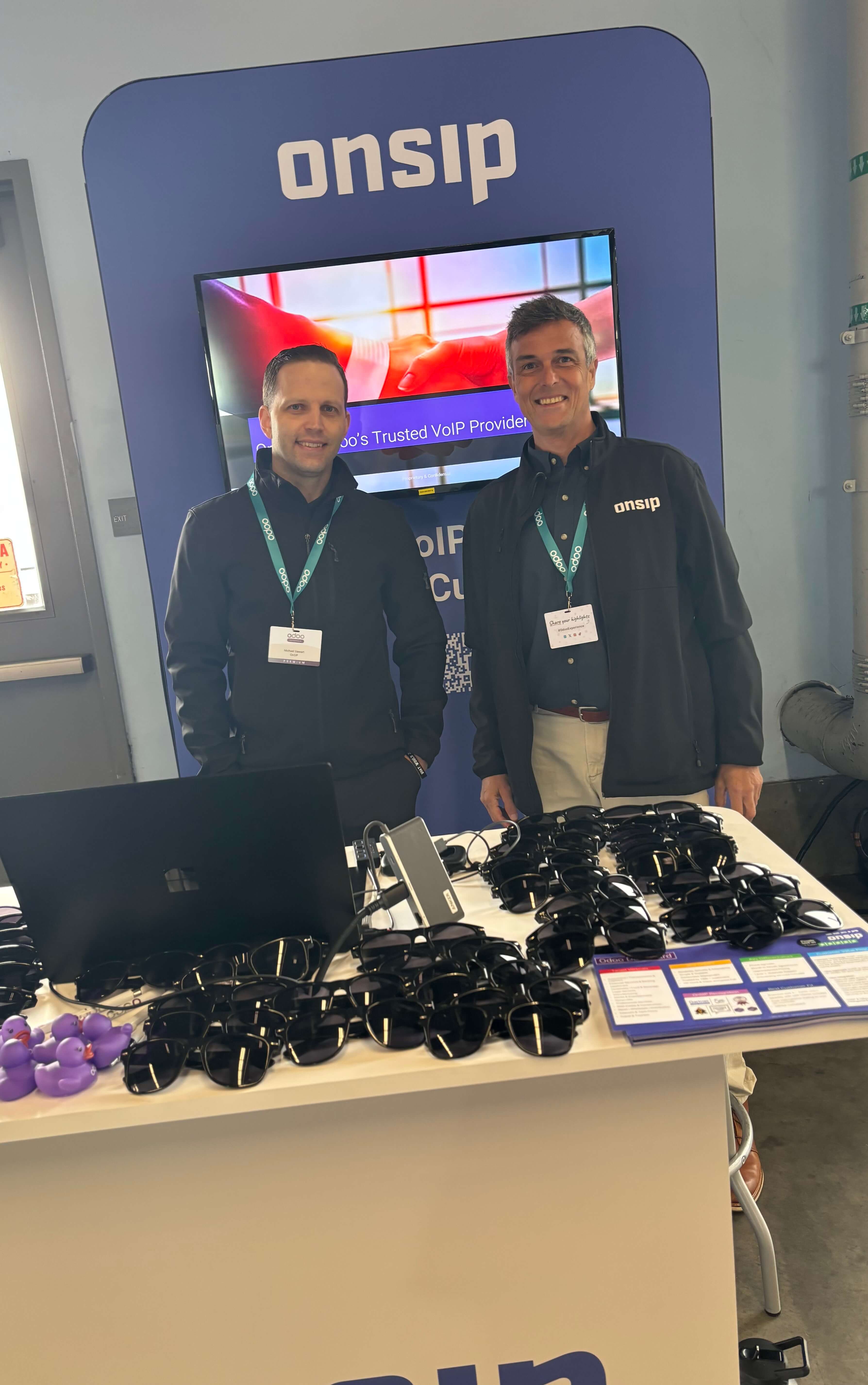 Picture of the OnSIP Team in front of our booth at the Odoo Experience Americas 2026.