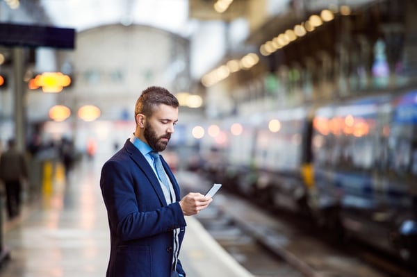 Businesswoman using voicemail to email to review her messages while commuting to work.