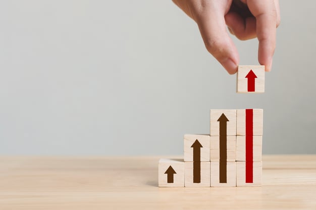 Graphic image of building blocks with arrows demonstrating how VoIP can scale with your business.