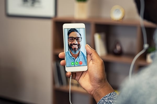 Business colleagues participating in a video conference call on a softphone.