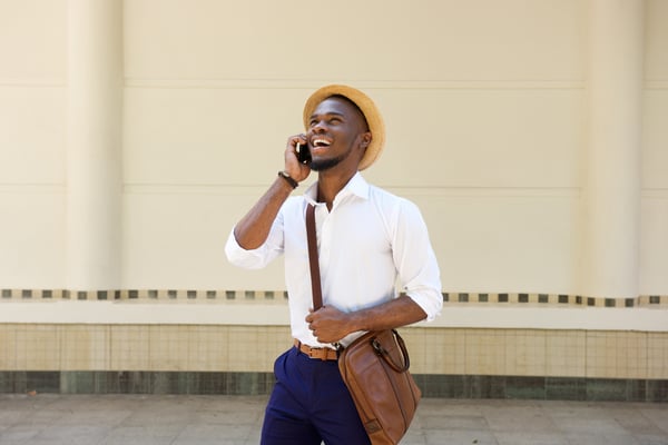 Businessman taking a call on a softphone outside of the office.