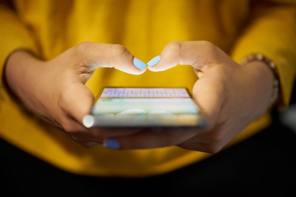 Woman texting on her mobile phone using VoIP.