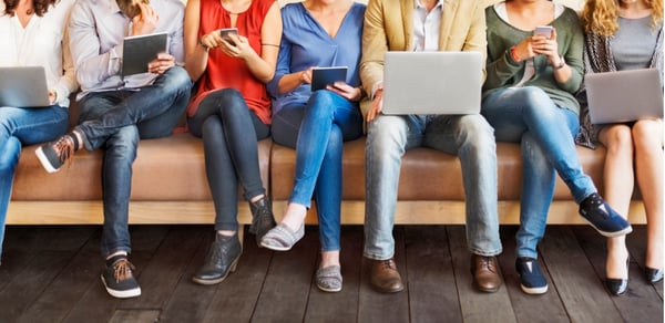 Group of colleagues using VoIP on various devices.