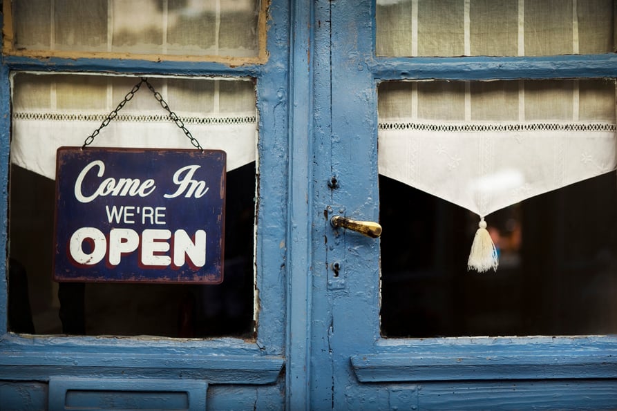 Classic open sign on a business's front door.