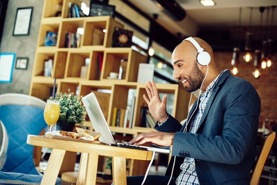 Executive on video phone call during office move at a cafe