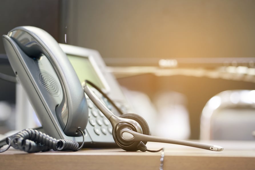 Classic desk phone with a headset.