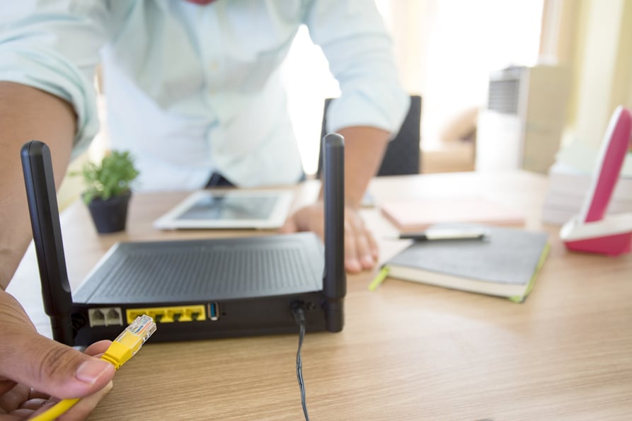 Person setting up a cloud phone system in a new office.