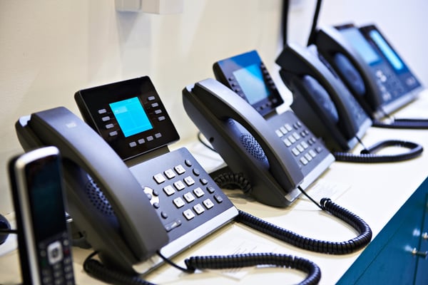 VoIP phones on a desk.