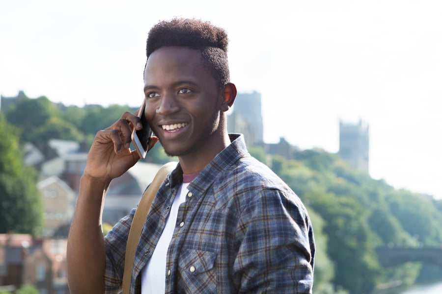 Man holding a smartphone up to his ear.