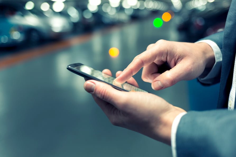 Picture of a businessman touching his smartphone.