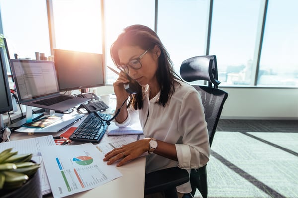 Female executive making a phone call at her desk.