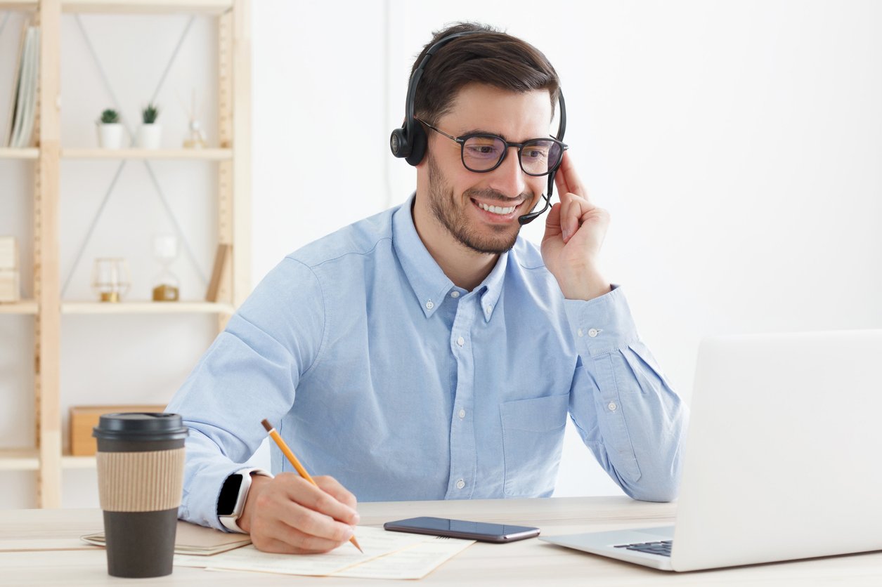 Businessman listening to a VoIP call recording in his hosted VoIP service's web portal.