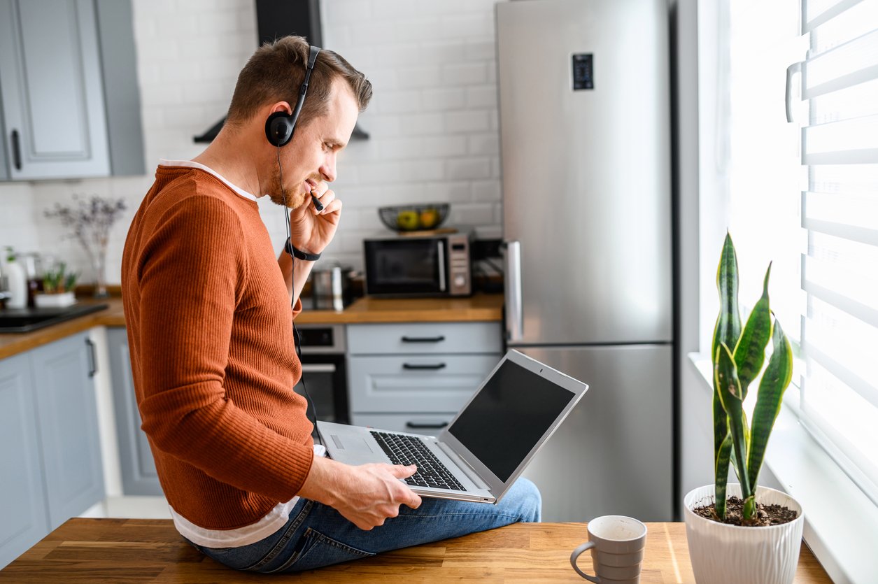 A customer support rep answers calls while working from home.