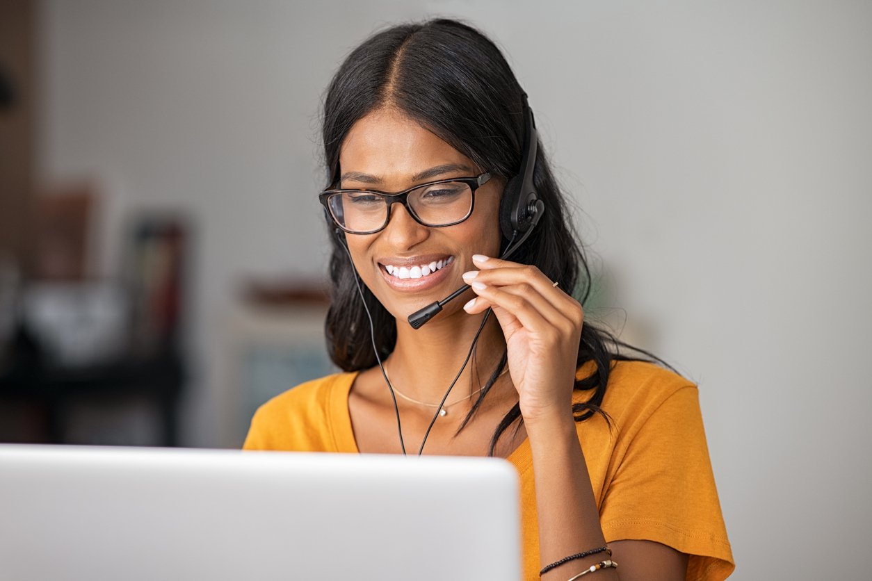 Businesswoman using a headset while on a VoIP call.