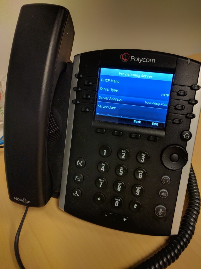 Picture of an IP phone sitting on a desk.