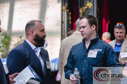 Mark Recene (left), CIO of HS Technology Group, speaks to Mike Curtin (right).