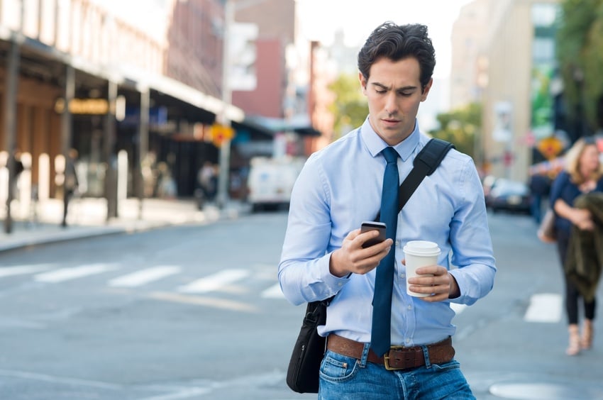 Man answering work calls on his smartphone