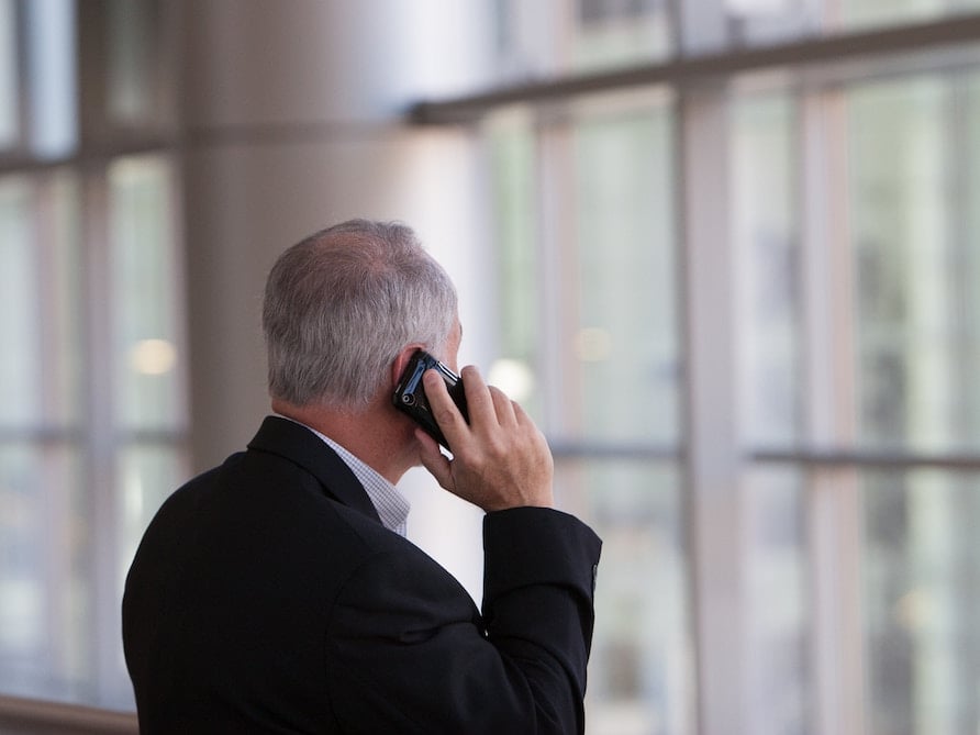 Businessman answering a work call on his smartphone.