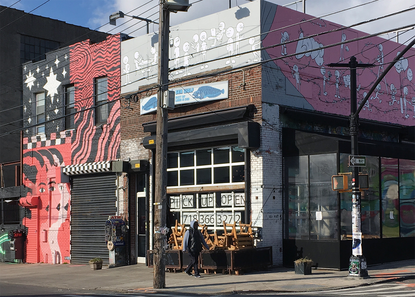 A Brooklyn restaurant posts signs in the window announcing it's open during Covid.